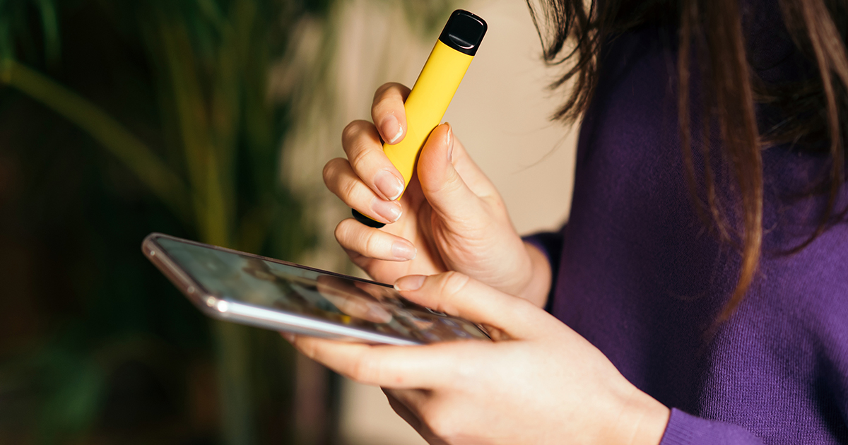 Girl on the phone and vaping