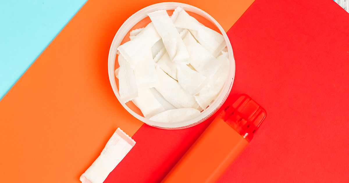 Nicotine Pouch and vape on orange background