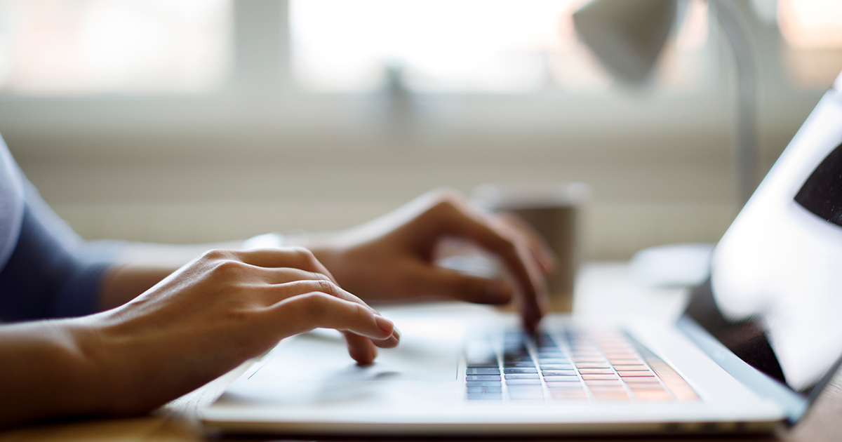 Typing on a laptop