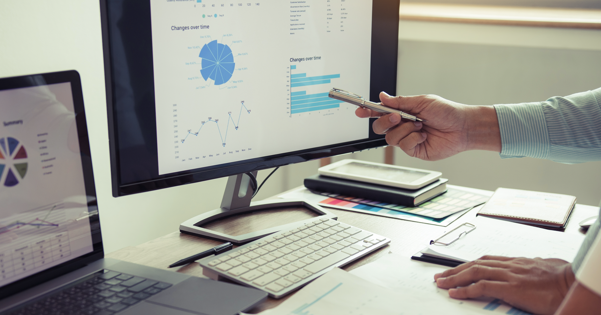 Researchers analyzing data on a large computer screen 