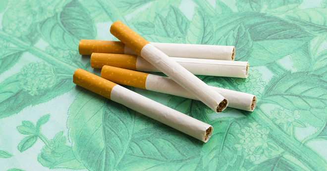 Menthol cigarettes on mint background