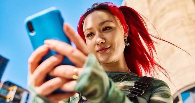 Girl with red hair using a cell phone